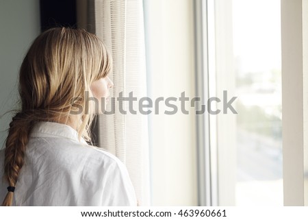 Similar – Image, Stock Photo Blonde woman looks through a window pane with reflections directly into the camera