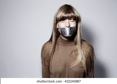 Young Blond Woman With Taped Mouth, Eyes Closed