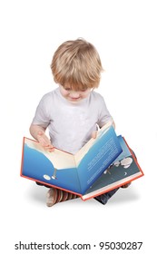 Young Blonde 4 Or 5 Year Old Boy Reading A Picture Book