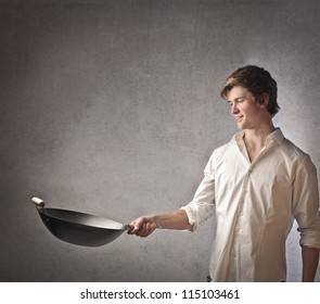 Young Blonde Boy Cooking With A Pan