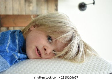 Young Blonde Boy Resting On A Bed Mattress