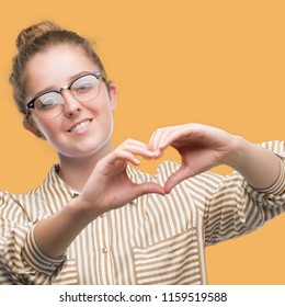 Young Blonde Business Woman Smiling In Love Showing Heart Symbol And Shape With Hands. Romantic Concept.