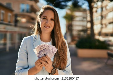 Young Blonde Businesswoman Smiling Happy Holding Sweden Krona Banknotes At The City.