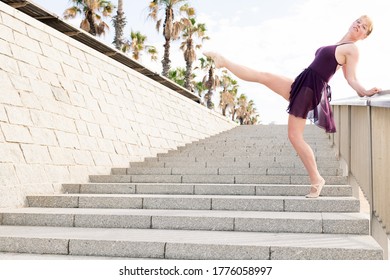 young blonde classical dancer dancing free on a stone staircase, dance concept and healthy lifestyle, copy space for text - Powered by Shutterstock