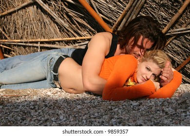 A young blonde couple lying in a romantic pose