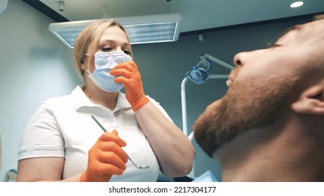 Young Blonde Doctor Treats Young Man's Teeth.