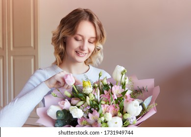 Young Blonde Girl A Bouquet Of Flowers As A Gift. Birthday Flower Delivery Is The Best Gift For A Woman.