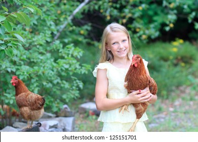 Young Blonde Girl in the Garden caring for Her Chickens in a Yellow Dress - Powered by Shutterstock