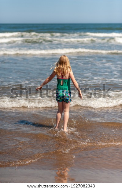 Young Blonde Girl Paddling Sea On Stock Photo 1527082343 | Shutterstock