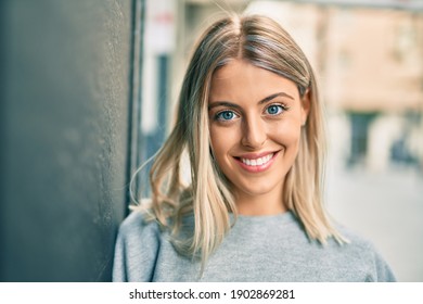 Young Blonde Girl Smiling Happy Standing At The City.