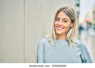 Young Blonde Girl Smiling Happy Standing At The City.