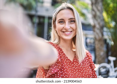 Young Blonde Girl Smiling Happy Making Selfie By The Camera At The City.