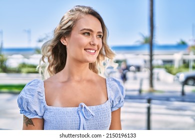 Young Blonde Girl Smiling Happy Standing At The Cityl