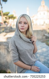 Young Blonde Girl In A Sweater With A Hood In Italy Rome