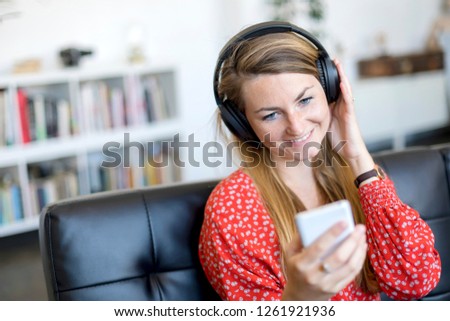 Similar – Happy woman listening to music wearing headphones