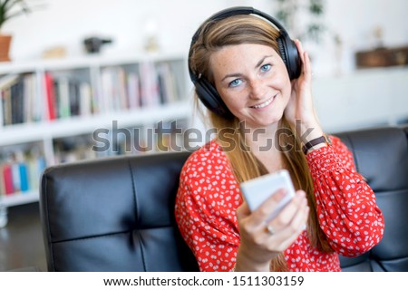 Similar – Happy woman listening to music wearing headphones