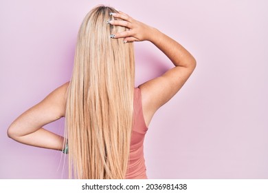 Young Blonde Girl Wearing Casual Clothes Backwards Thinking About Doubt With Hand On Head 