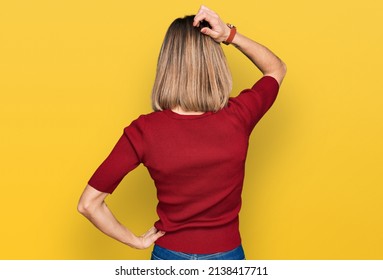 Young Blonde Girl Wearing Casual Clothes Backwards Thinking About Doubt With Hand On Head 