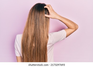 Young Blonde Girl Wearing Casual Clothes Backwards Thinking About Doubt With Hand On Head 