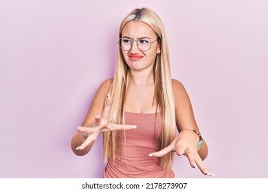 Young Blonde Girl Wearing Casual Clothes Disgusted Expression, Displeased And Fearful Doing Disgust Face Because Aversion Reaction. 