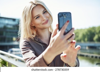 Young Blonde Lady With A Smartphone