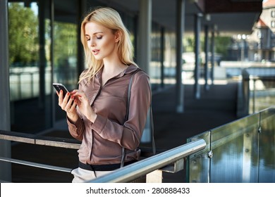 Young blonde lady with a smartphone - Powered by Shutterstock