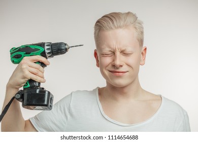 young-blonde-man-drilling-his-260nw-1114654688.jpg