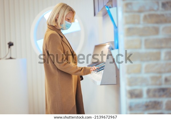 The\
young blonde is thinking about buying a new tablet computer and\
needs an expert opinion. The store is modern, bright and has all\
new devices. She is excited about the new\
purchase