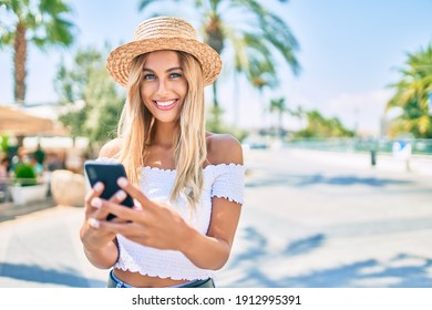 Young blonde tourist girl smiling happy using smartphone at the city. - Powered by Shutterstock