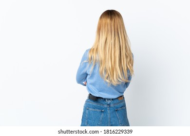 Young Blonde Uruguayan Woman Over Isolated Background In Back Position