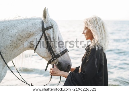 Similar – Image, Stock Photo Portrait of adult woman with beautiful horse in nature. Sunlight, silhouette.Concept of love for lesser brothers, caring and animal training