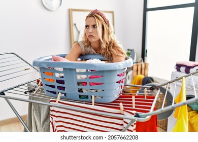Young Blonde Woman Boring Doing Laundry At Laundry Room