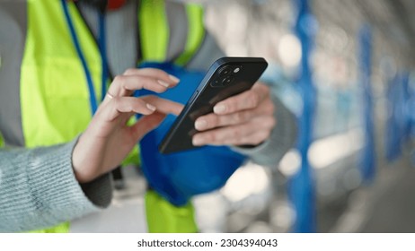 Young blonde woman builder using smartphone at street - Powered by Shutterstock