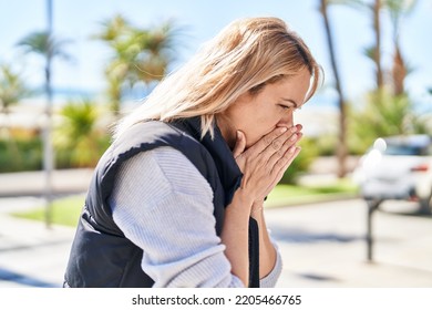 Young Blonde Woman Coughing At Park