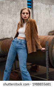 Young Blonde Woman In Denim Jeans And Suede Blazer Posing On Rooftop