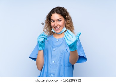 Young Blonde Woman Dentist Holding Tools Isolated On Blue Background Inviting To Come