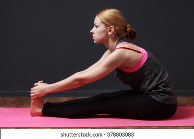 Young Blonde Woman Doing Yoga Exercise Seated Forward Fold 