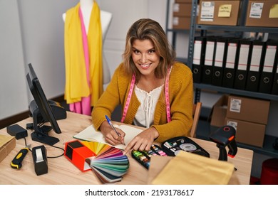 Young Blonde Woman Dressmaker Choosing Cloth Color At Designer Studio