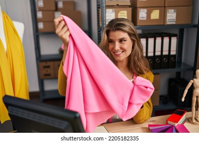 Young Blonde Woman Dressmaker Holding Cloth At Designer Studio