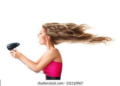 Young blonde woman drying long hair with electric fan isolated on white background