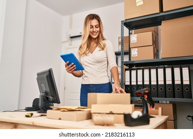 Young blonde woman ecommerce business worker using touchpad working at office - Powered by Shutterstock