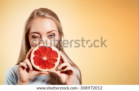 Similar – Image, Stock Photo Young blonde woman holding orange leaf