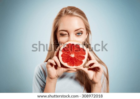 Similar – Image, Stock Photo Young blonde woman holding orange leaf