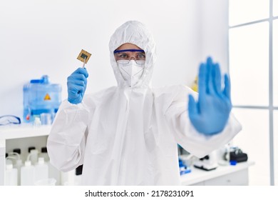 Young Blonde Woman Holding Cpu Computer Processor At Laboratory With Open Hand Doing Stop Sign With Serious And Confident Expression, Defense Gesture 