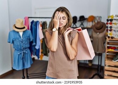 Young Blonde Woman Holding Shopping Bags At Retail Shop Yawning Tired Covering Half Face, Eye And Mouth With Hand. Face Hurts In Pain. 