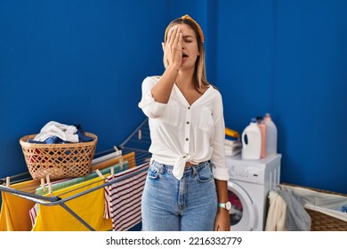 Young Blonde Woman At Laundry Room Yawning Tired Covering Half Face, Eye And Mouth With Hand. Face Hurts In Pain. 