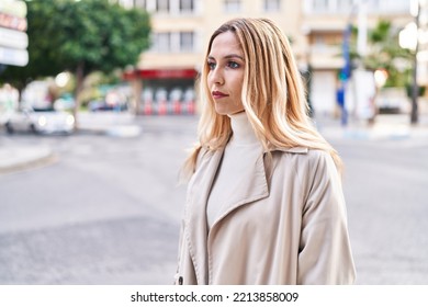 Young Blonde Woman Looking To The Side With Serious Expression At Street