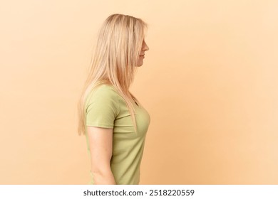 young blonde woman on profile view thinking, imagining or daydreaming - Powered by Shutterstock