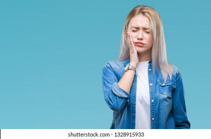 Young blonde woman over isolated background touching mouth with hand with painful expression because of toothache or dental illness on teeth. Dentist concept.