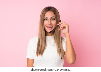 Young Blonde Woman Over Isolated Pink Background Working With Headset